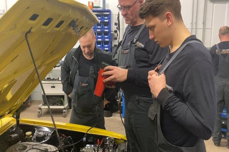 Mechatronics engineers and trainees work on the Lancer engine