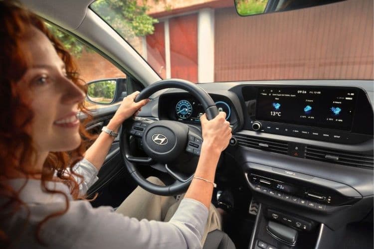 A woman takes a test drive in a Hyundai.