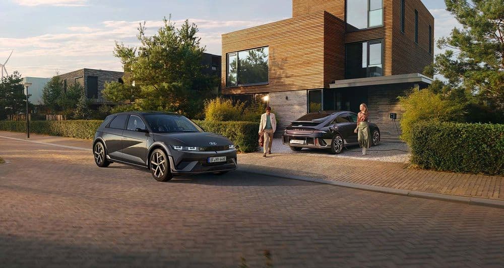 Hyundai IONIQ 5 and IONIQ 6 parked in front of family home with wallbox